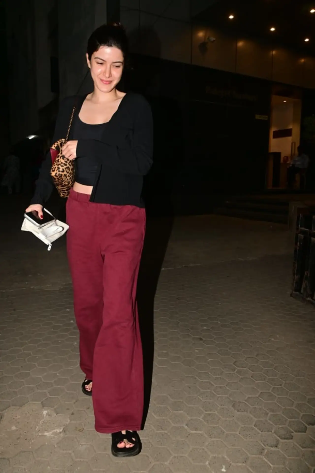 Shanaya Kapoor exuded a relaxed, laid-back vibe in a black top paired with a shrug and red pants.